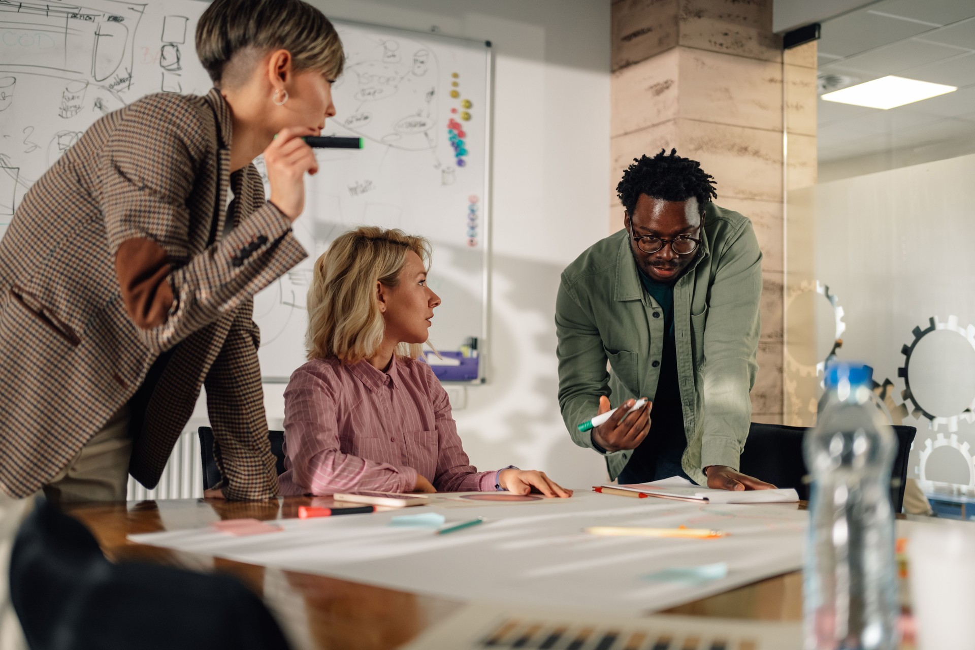 Marketing team analyzing diagrams and graphs during a meeting